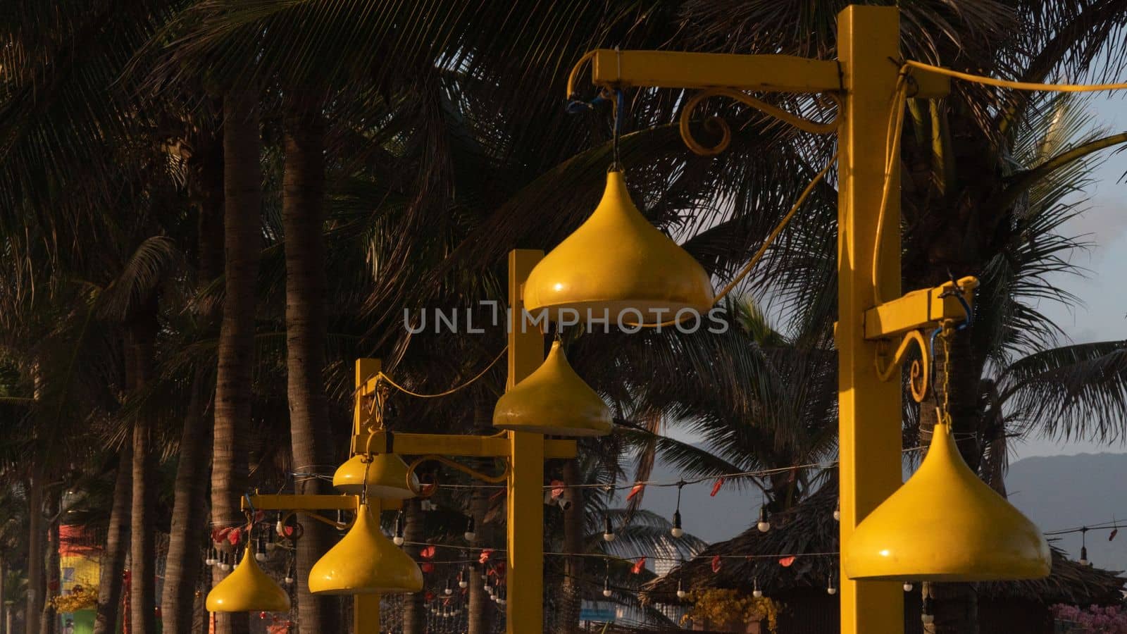 Close-up of yellow street lights on the beachfront promenade in the evening by voktybre