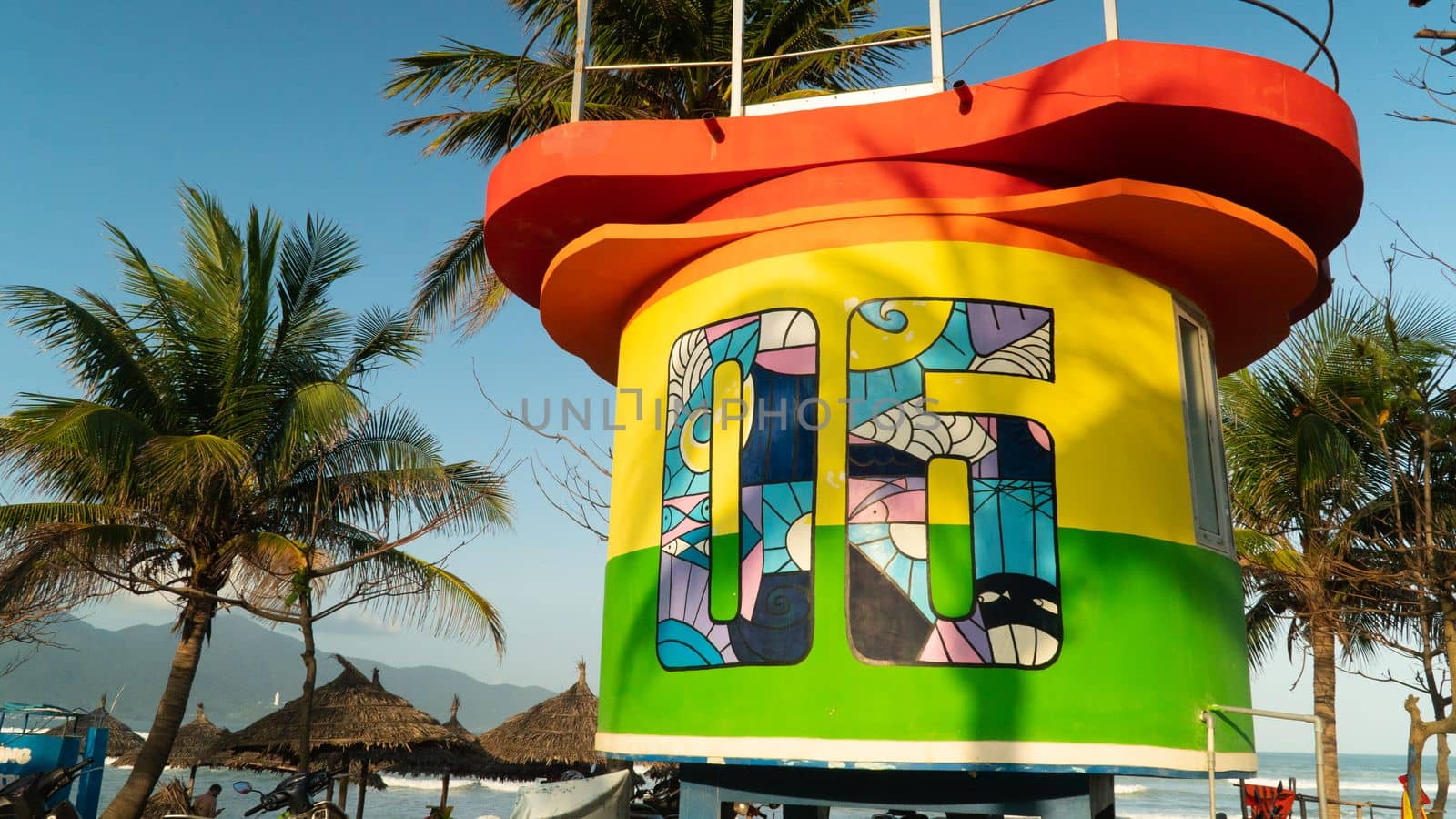 Multicolored bright lifeguard booth on the sea beach by voktybre