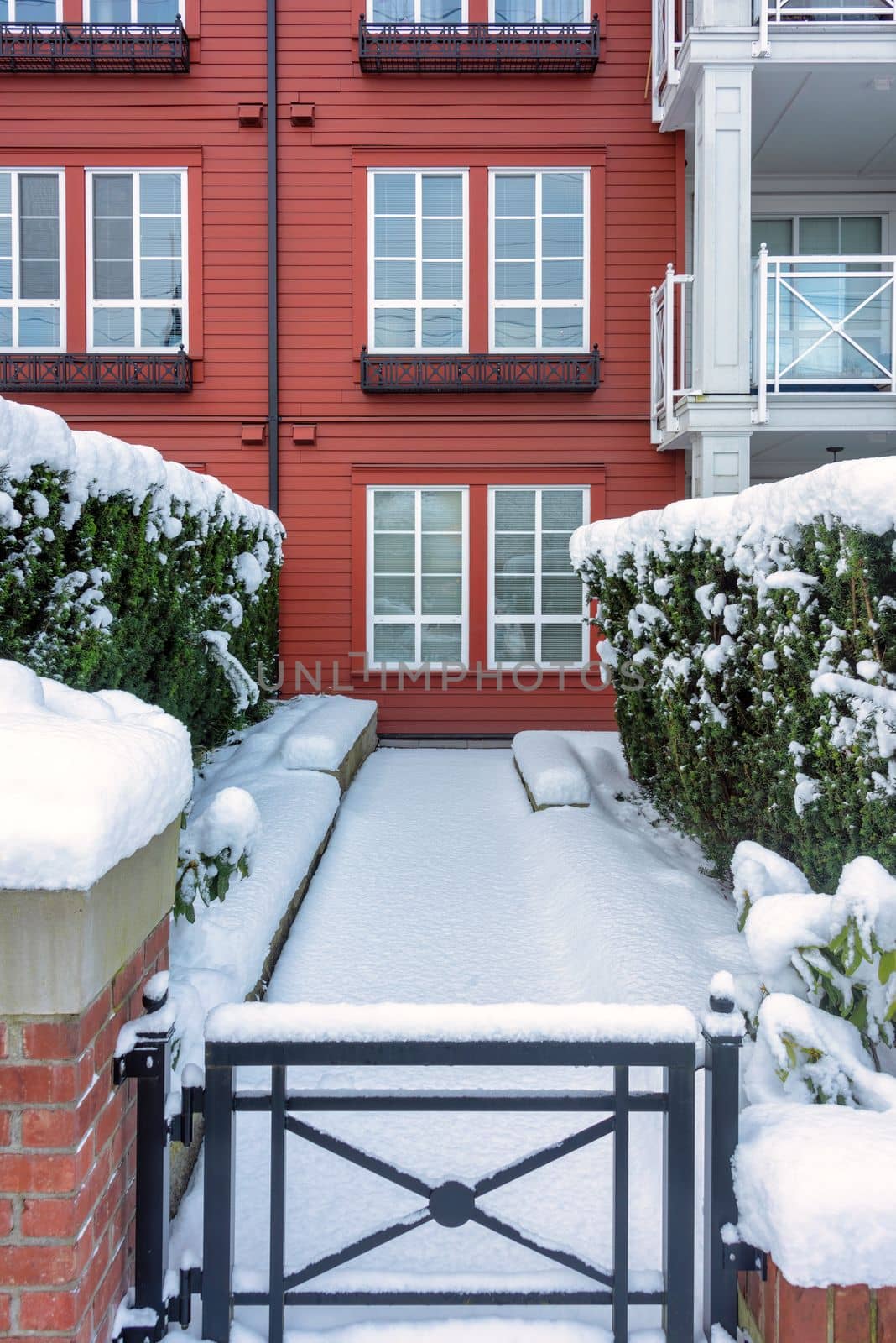 Pathway to residential building covered with snow. Residence on the winter season.