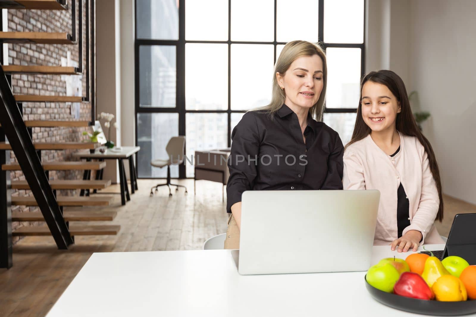 Mother And Daughter Using Digital Devices.