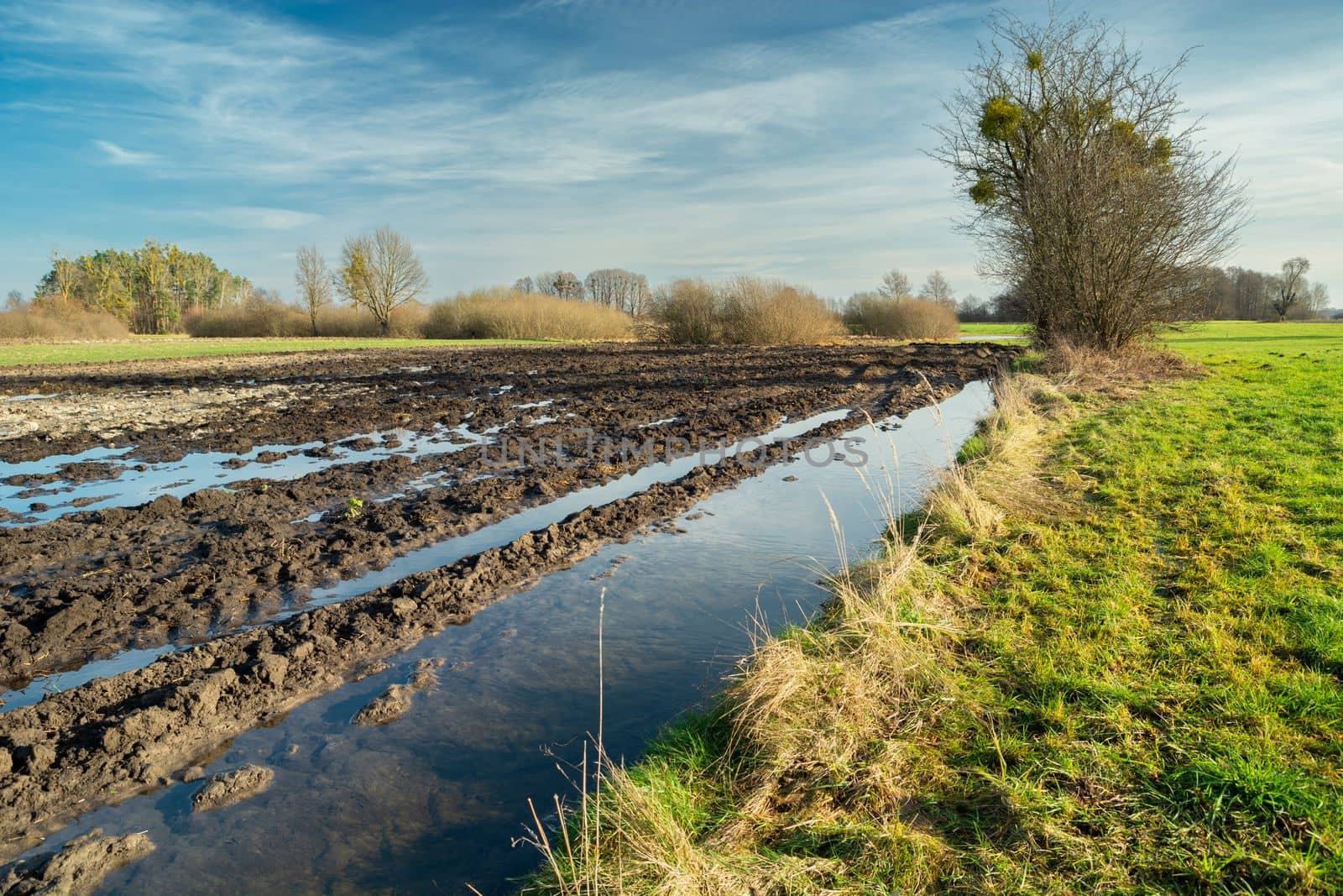 Water after melting snow on a plowed field, Nowiny, Poland by darekb22
