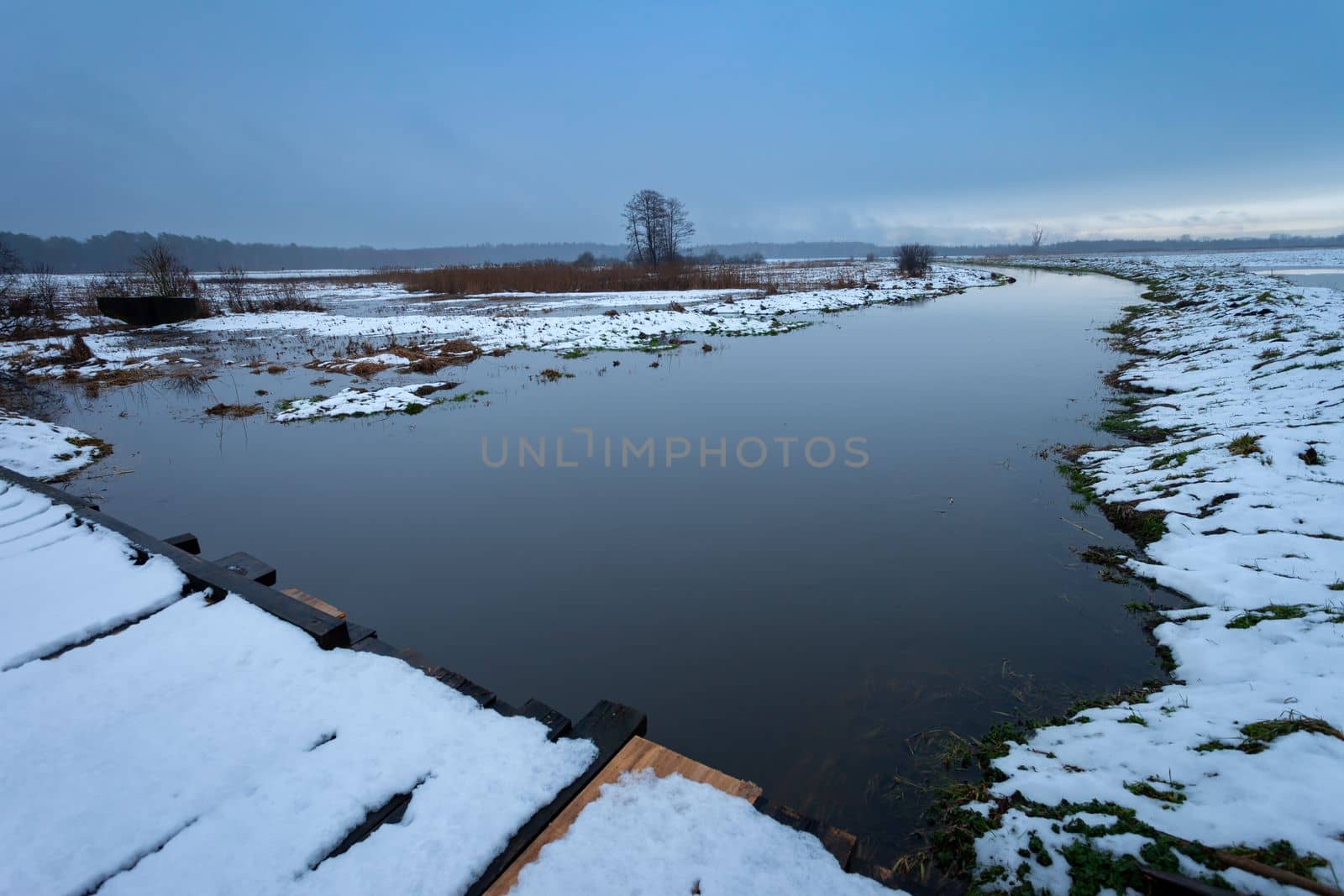 View from the bridge on the river Uherka flooding the meadows, Czulczyce, Poland by darekb22