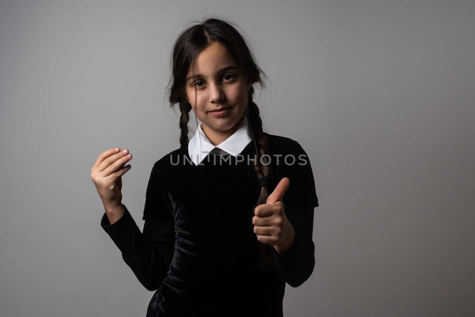 A girl with braids in a gothic style on a dark background