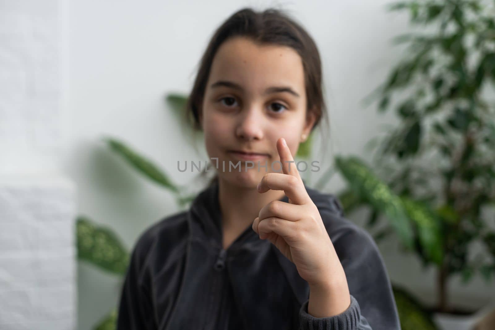A smiley teenage girl hand sign.