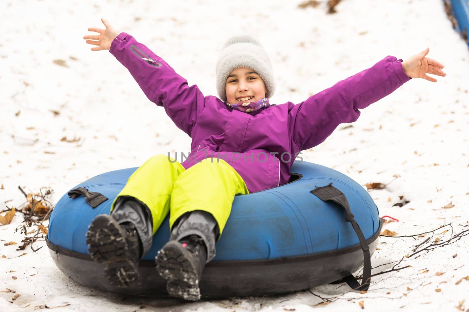 Children ride on tubing. Winter entertainment. Tubing. People roll on the slides