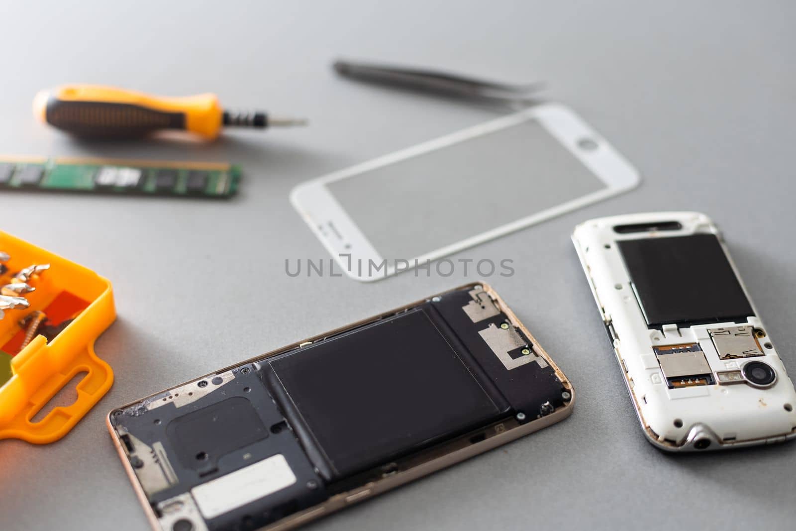 Technician repairing mobile phone at table, closeup by Andelov13