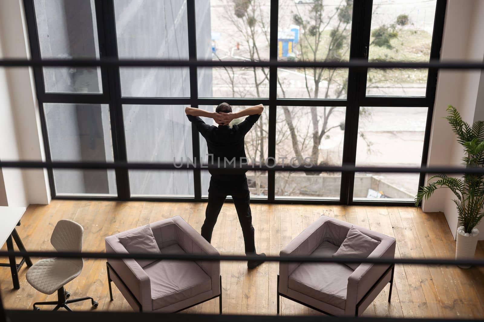 Mock Up Template. Happy Smiling Man Sitting On Desk Posing At Home Office, Free Copy Space. People, Technology, Remote Work Concept by Andelov13