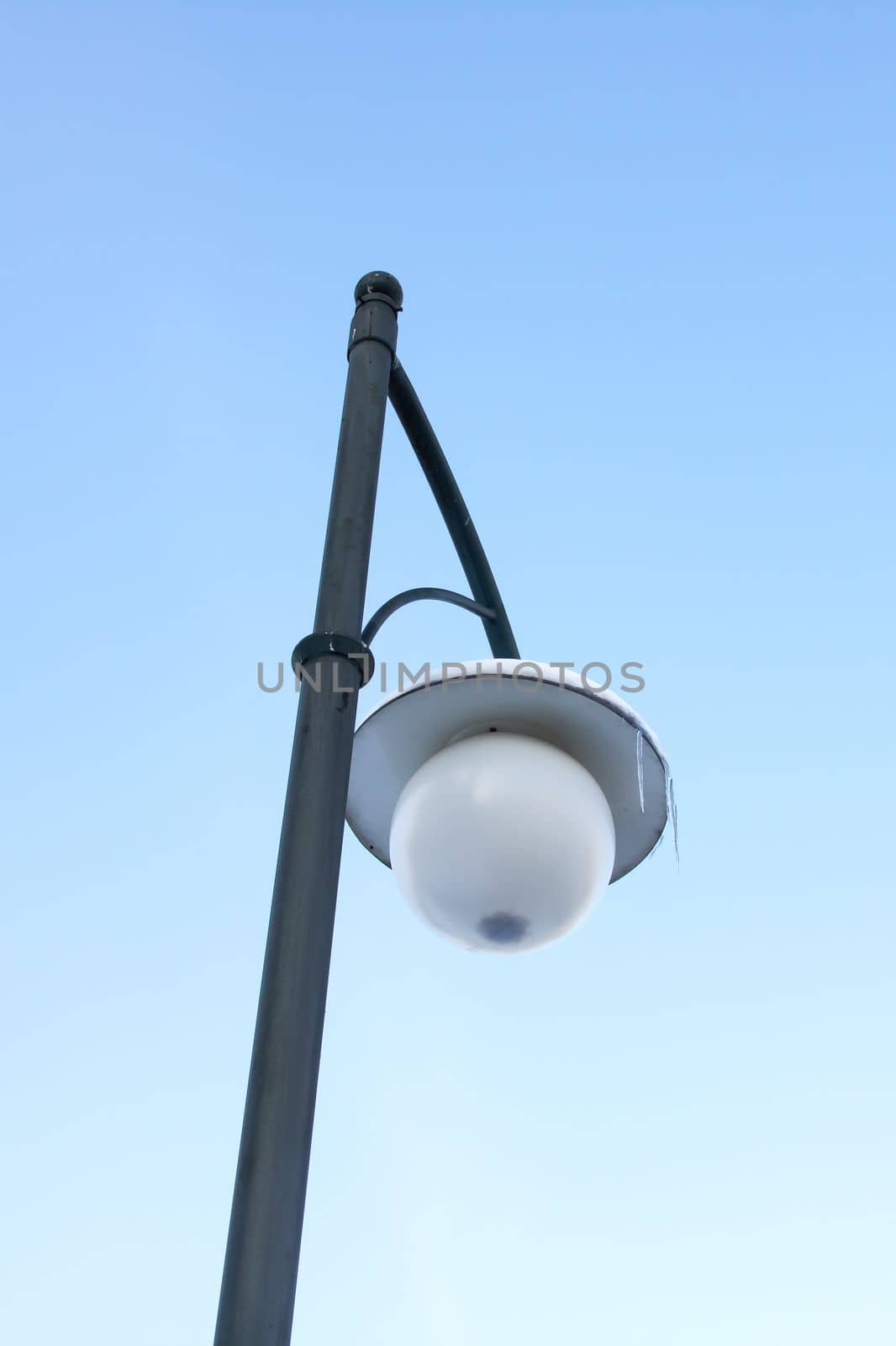 Street lantern under the snow and ice close up