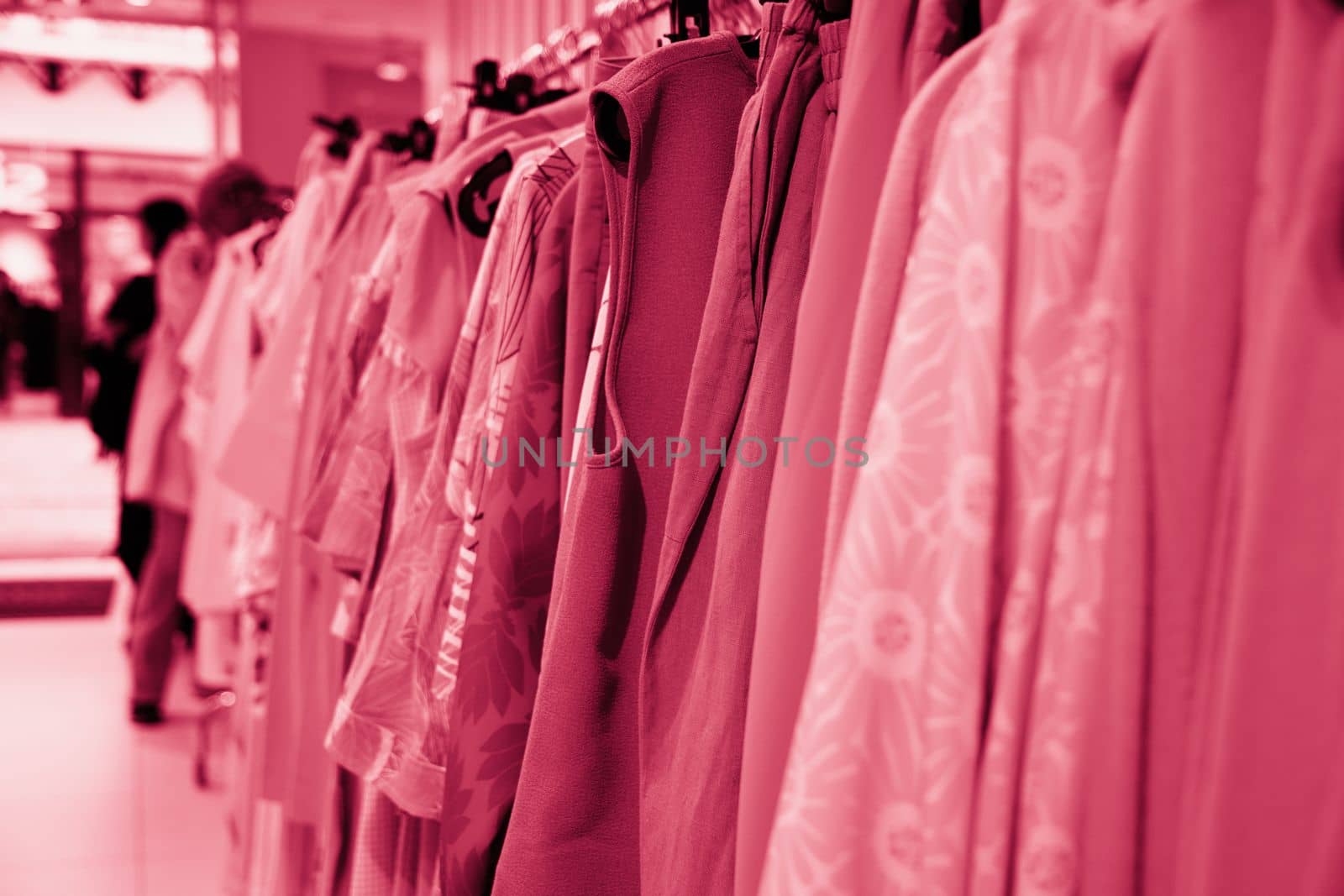 summer blouses on a hanger in the store, concept color of the year 2023 Viva Magenta, High quality photo