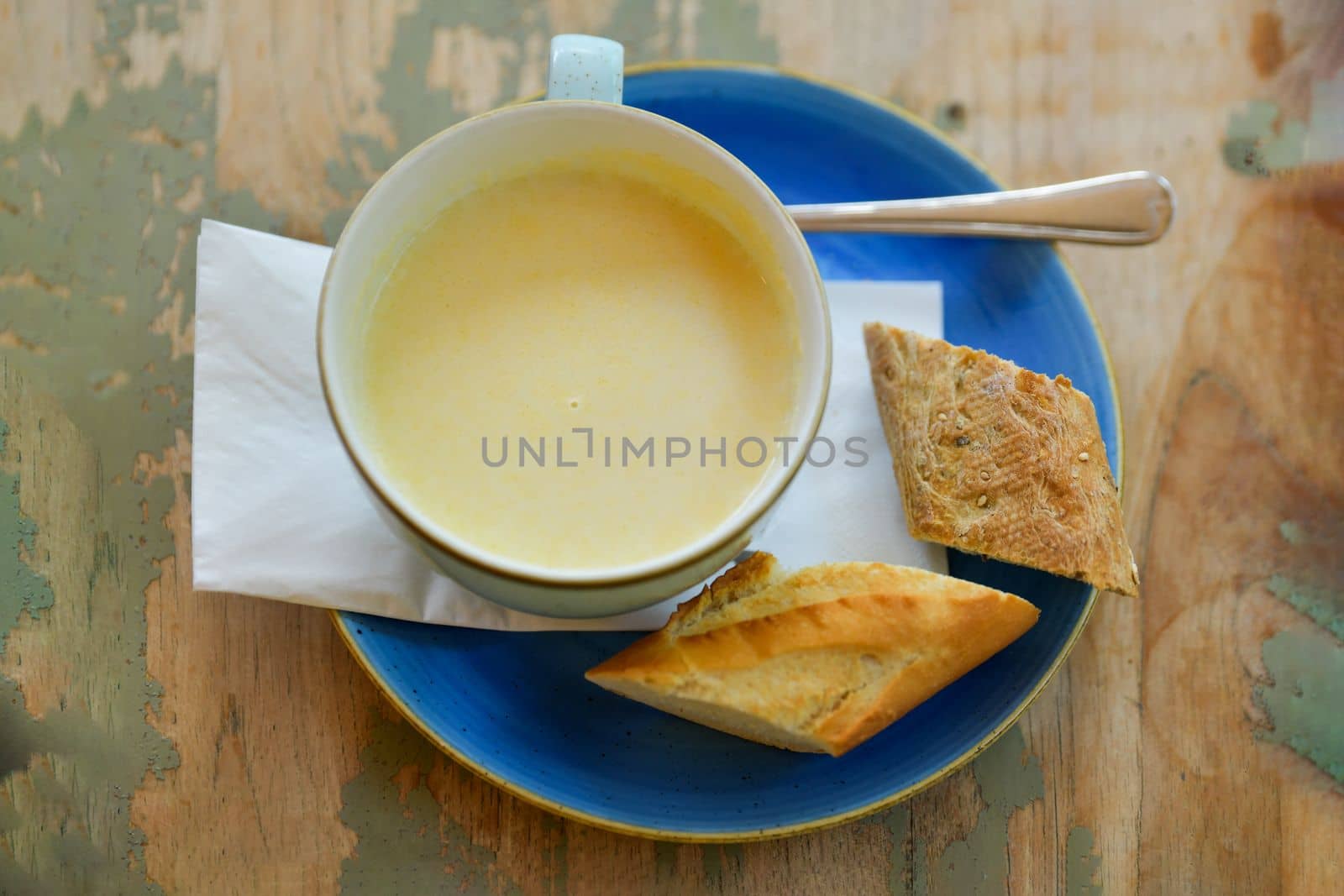 White asparagus soup on a shabby table in a restaurant