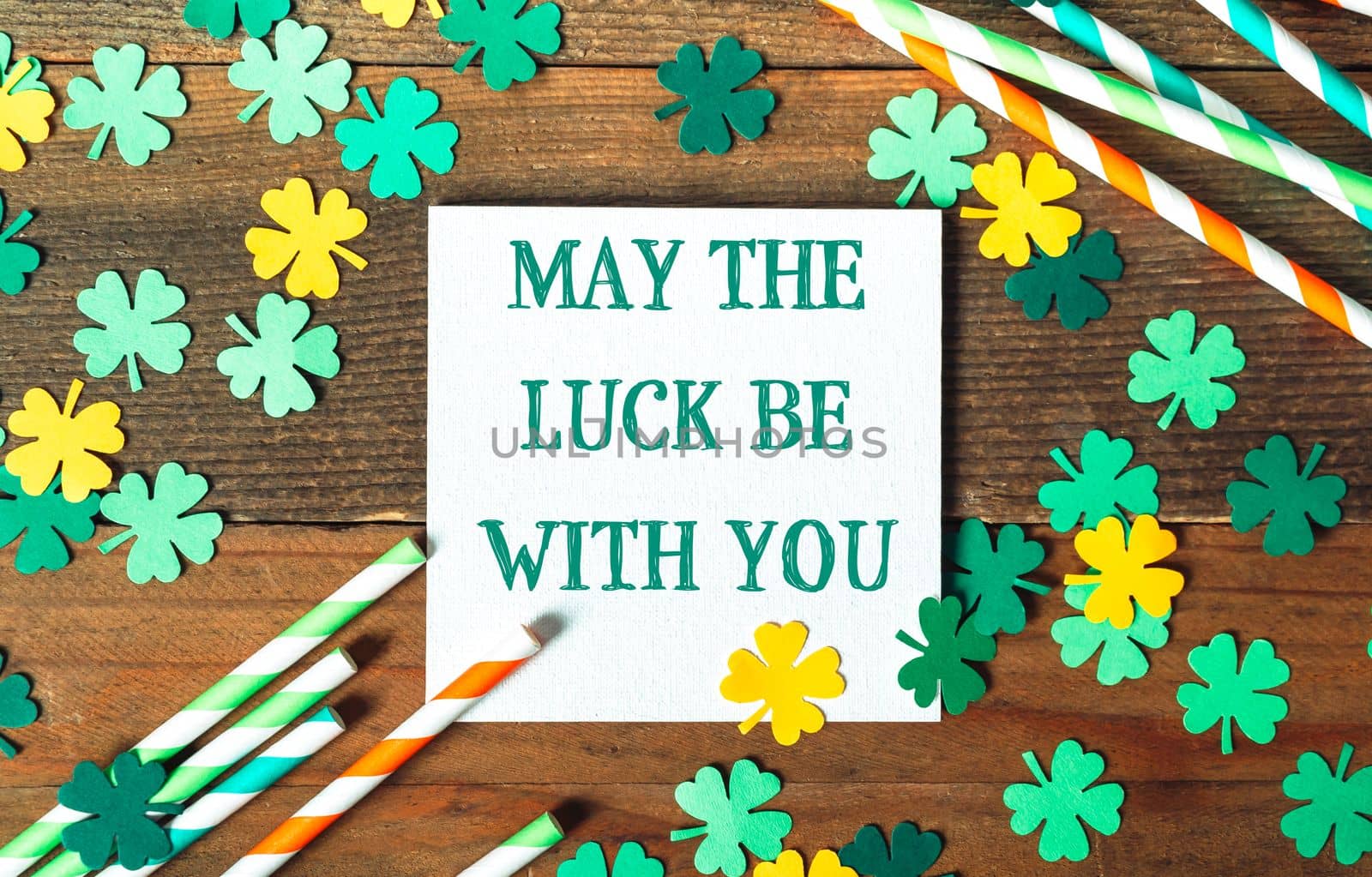 st. patrick's day greeting card on wooden background with clover