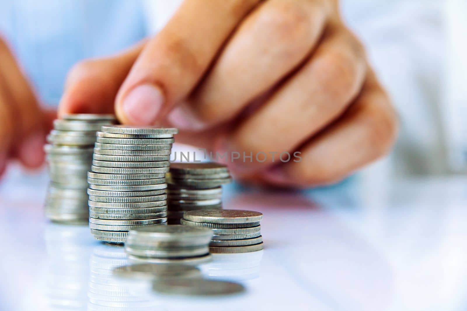 Hand put coin to stack, investment concept