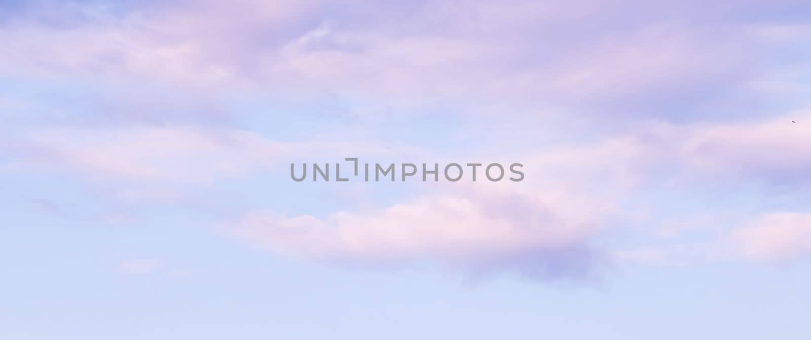 Blue sky background with white and pink clouds at sunset by Olayola