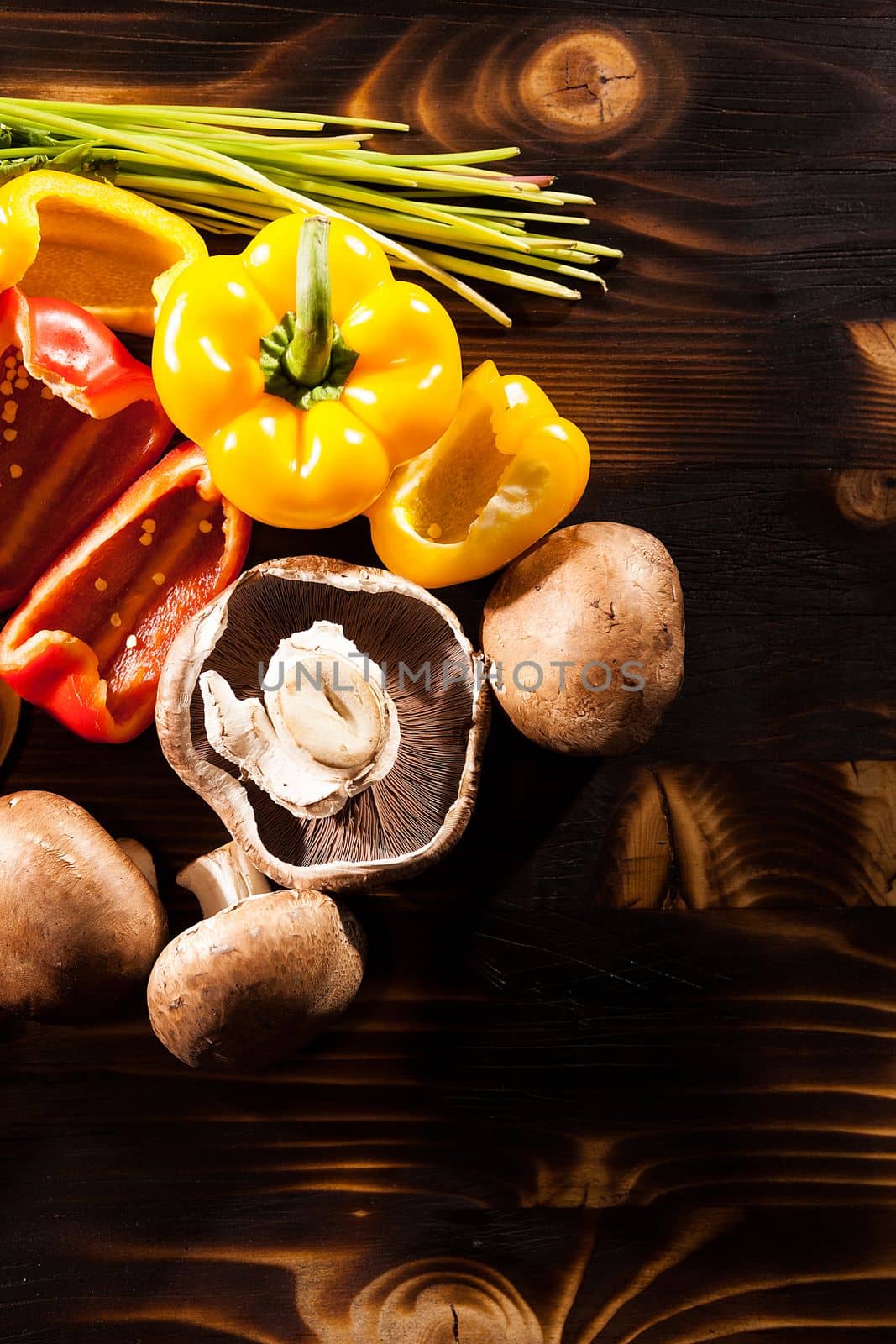 Different type of fresh organic vegetables on burned wooden back by DCStudio