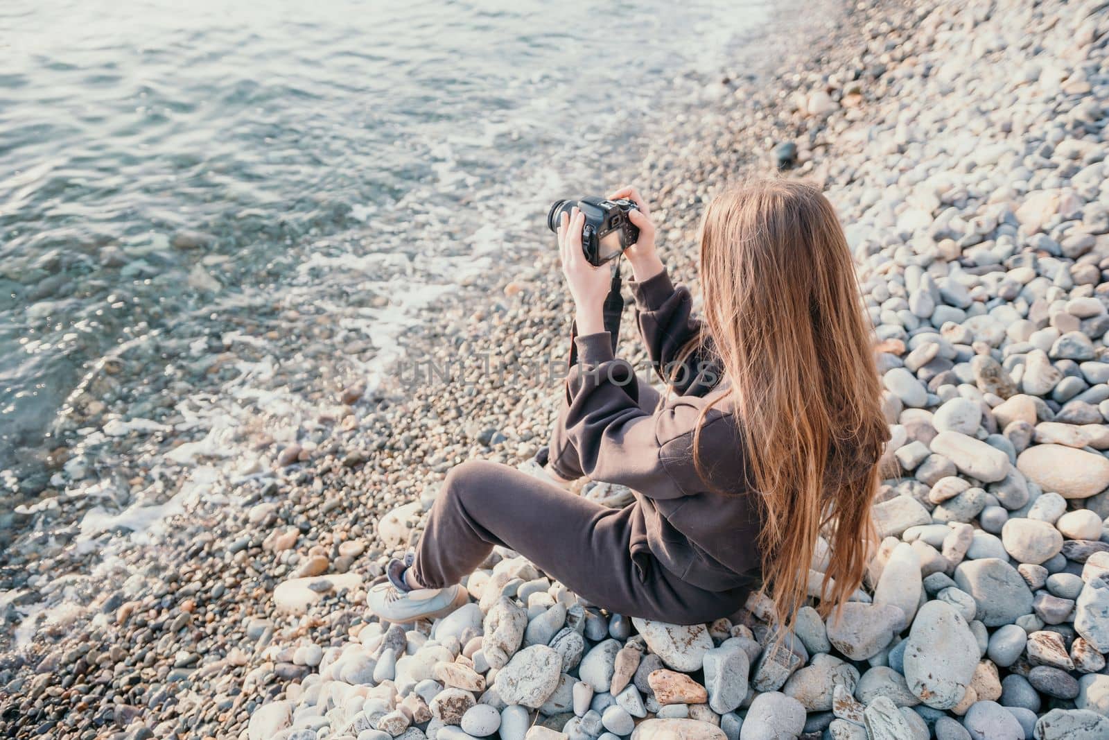 Woman travel sea. Happy tourist enjoy taking picture outdoors for memories. Woman traveler looks at sea bay of mountains, sharing travel adventure journey by panophotograph