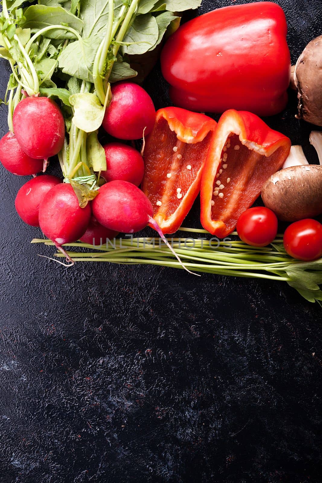 Different type of organic healthy vegetables on dark wooden background. Copy space available for text