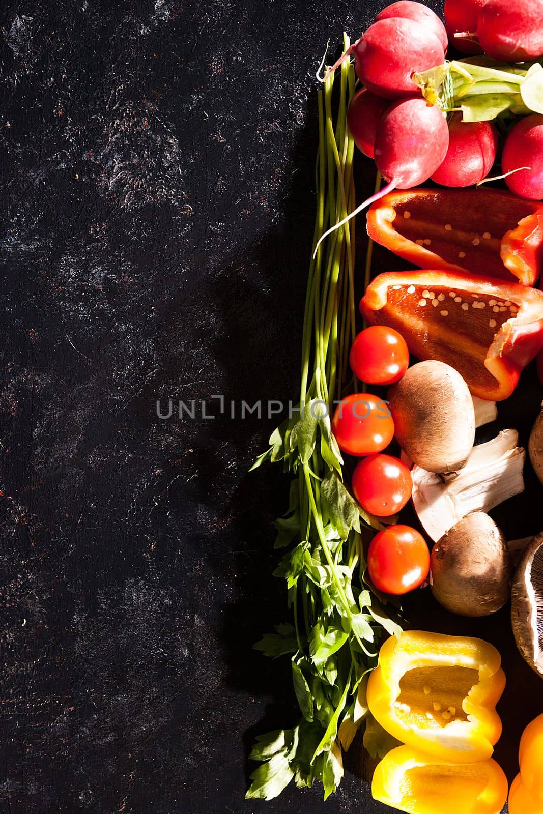 Different type of organic healthy vegetables on dark wooden back by DCStudio