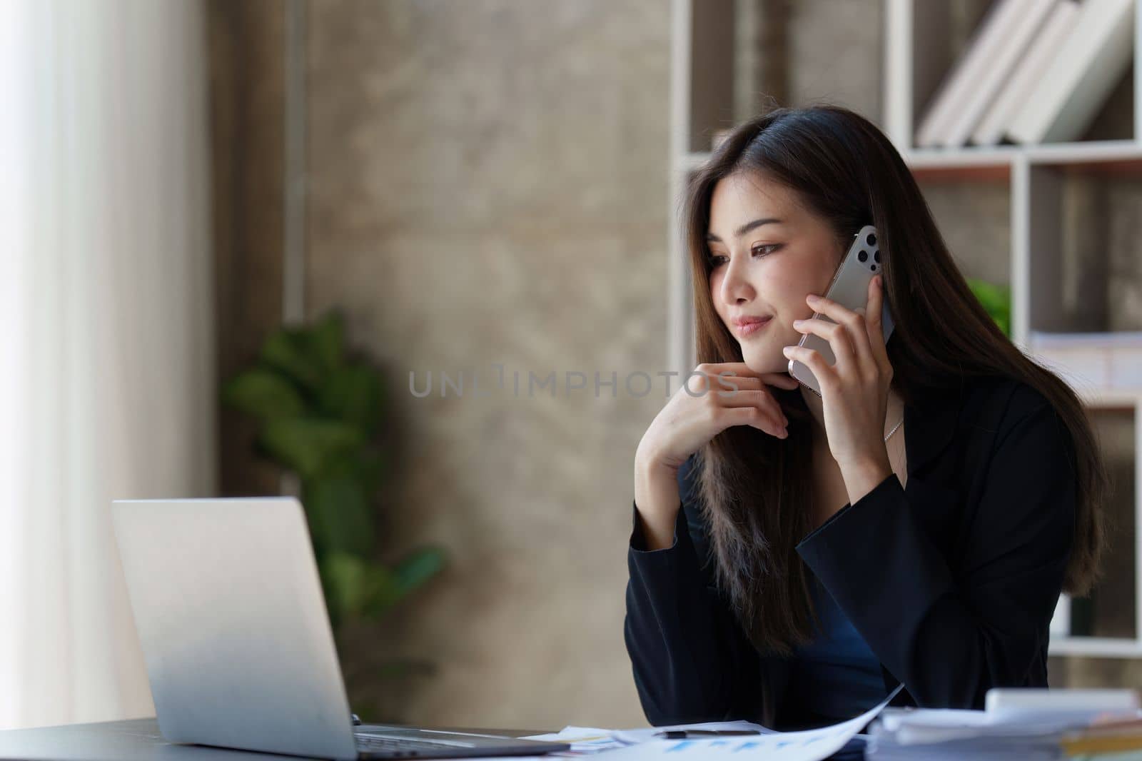 Beautiful business woman talking on the mobile phone. Management, planning and networking phone call concept by itchaznong