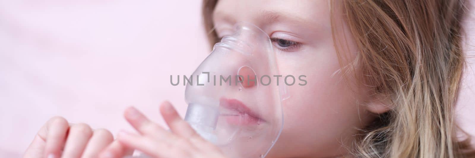 Portrait of child girl with inhaler for asthma. Oxygen mask for children concept