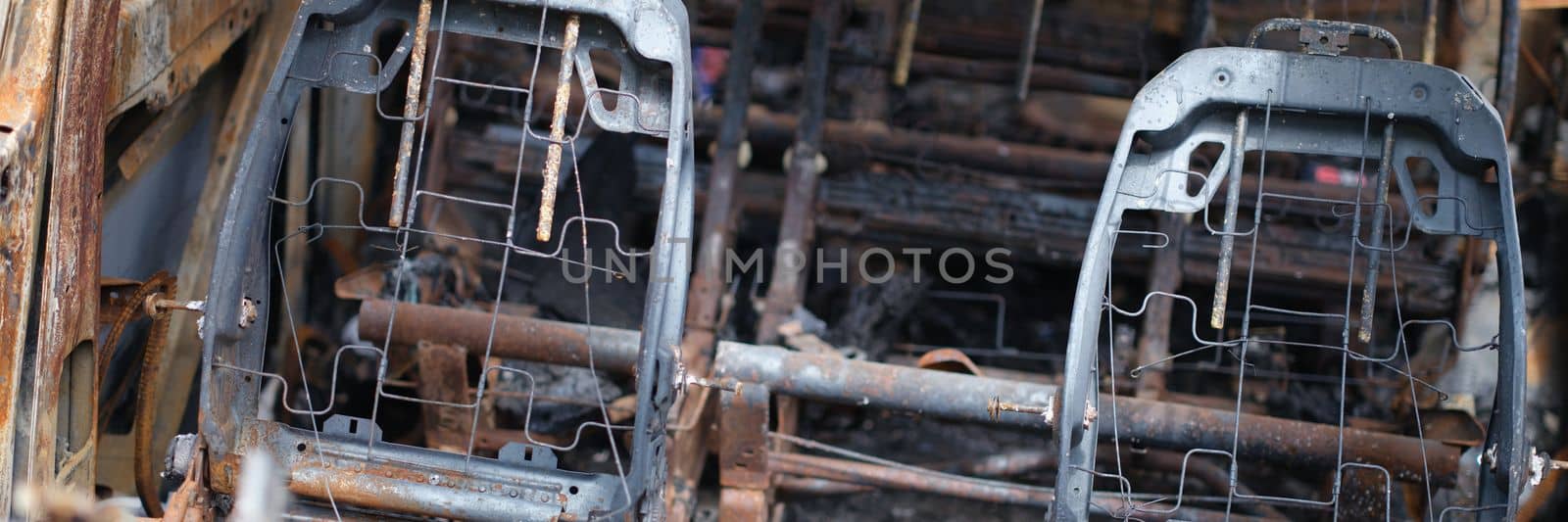 Passenger car closeup got into accident on road and burned after accident. Burnt rusty abandoned car concept