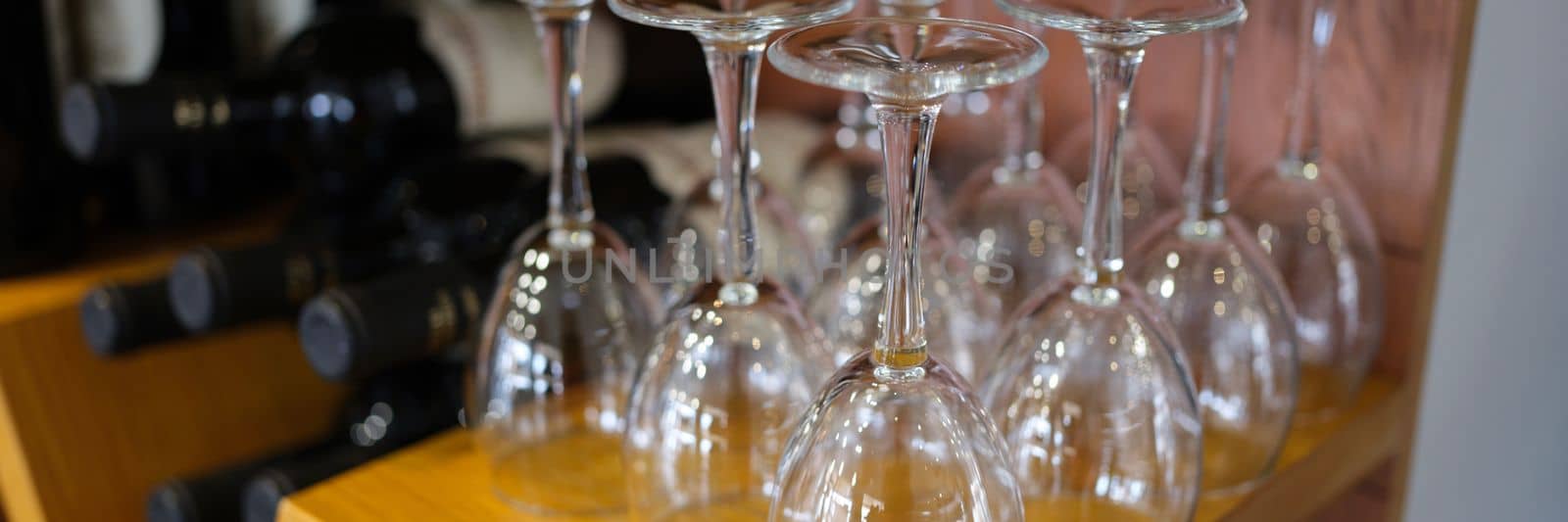 Wine bar with empty glasses and bottles of elite wine by kuprevich
