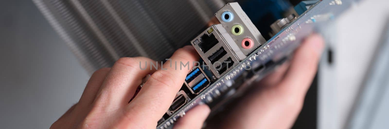 Motherboard hand holder port in laptop computer closeup. Computer equipment repair concept