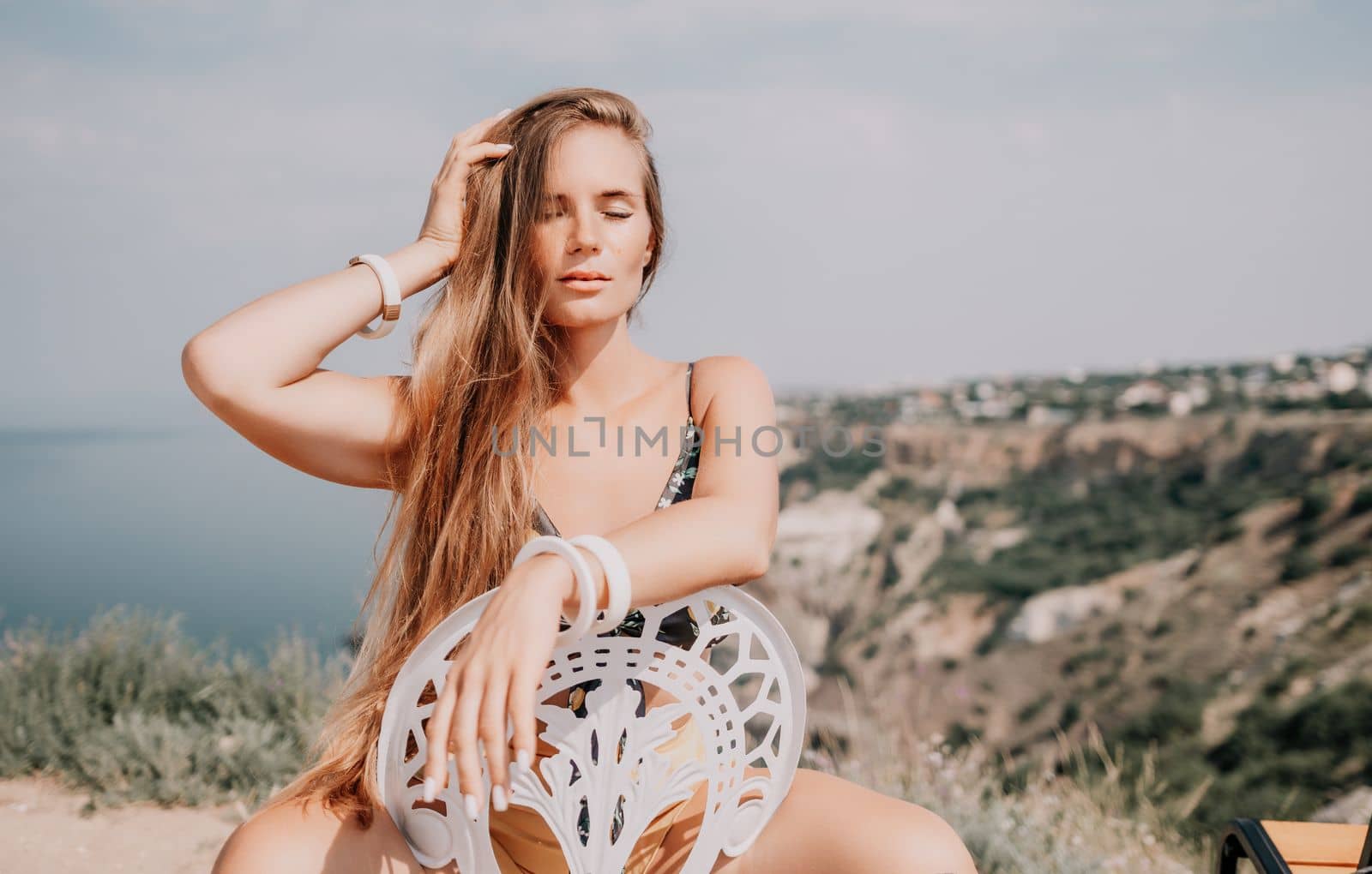 Happy boho woman portrait. Boho chic fashion style. Outdoor photo of free happy woman with long hair, sunny weather outdoors with sea mountains nature beautiful background. by panophotograph