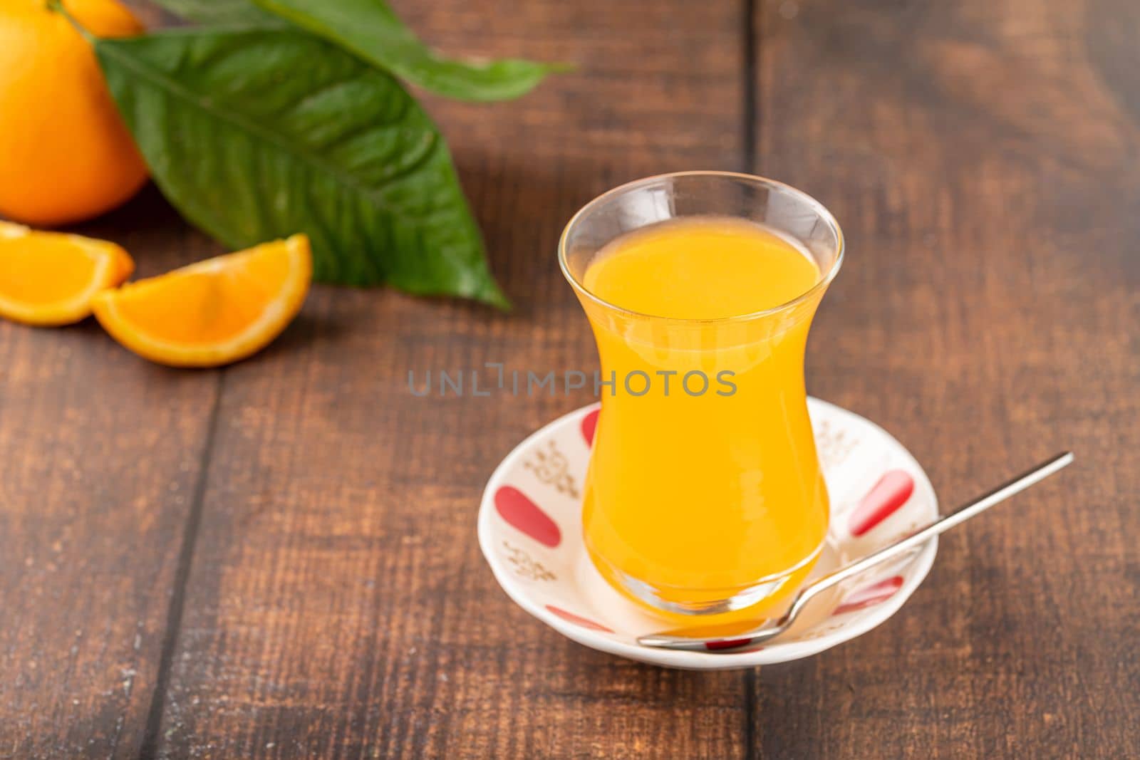 Winter drink orange oralet or oralette in a thin-waisted glass tea glass by Sonat
