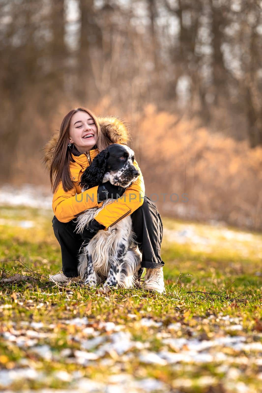 young teenage girl plays with her dog in nature. english setter by Edophoto