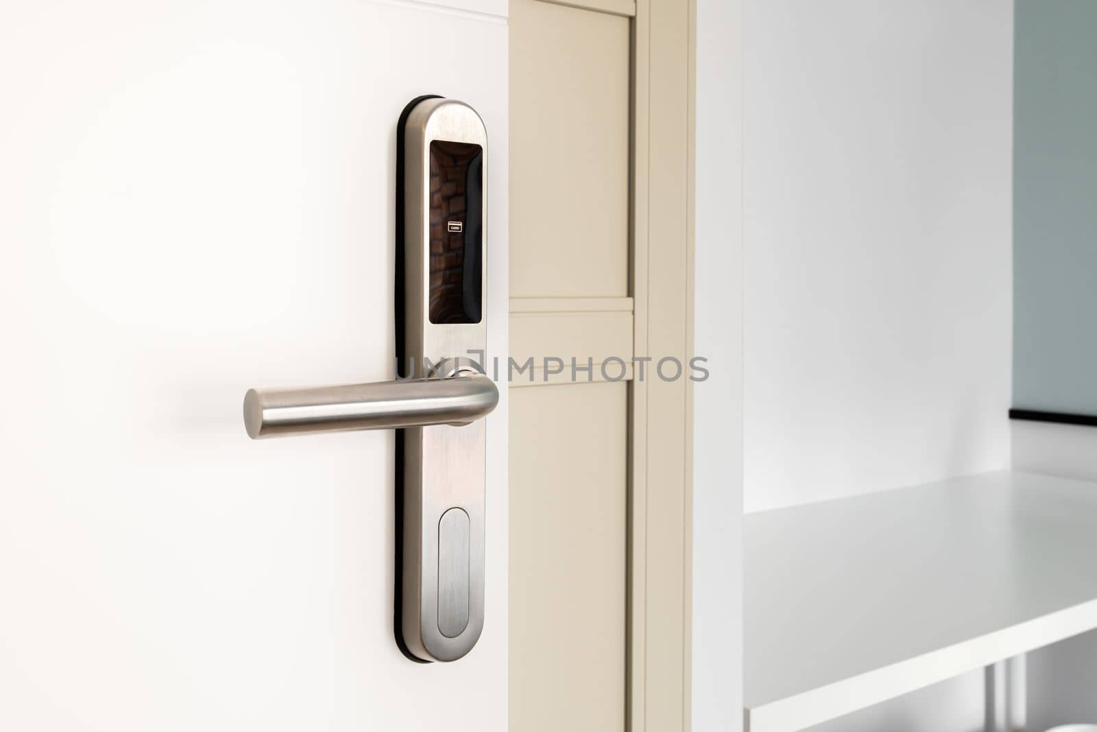 Open front door with electronic mortise lock and handle. The door is opened with a combination of a digital code or a plastic card. Modern door opening and property security systems. by apavlin