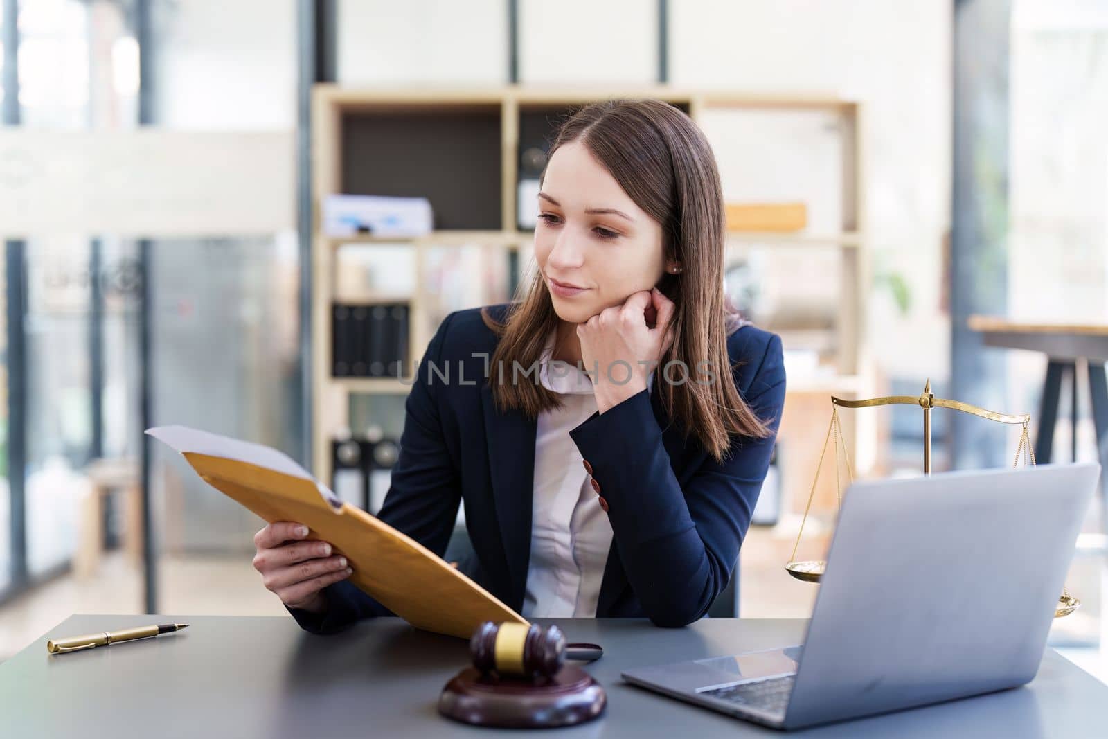 Business Lawyer consulting online on laptop while working at office..