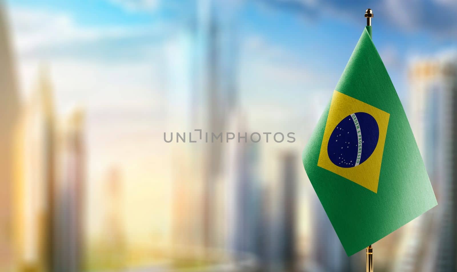 Small flags of the Brazil on an abstract blurry background by butenkow