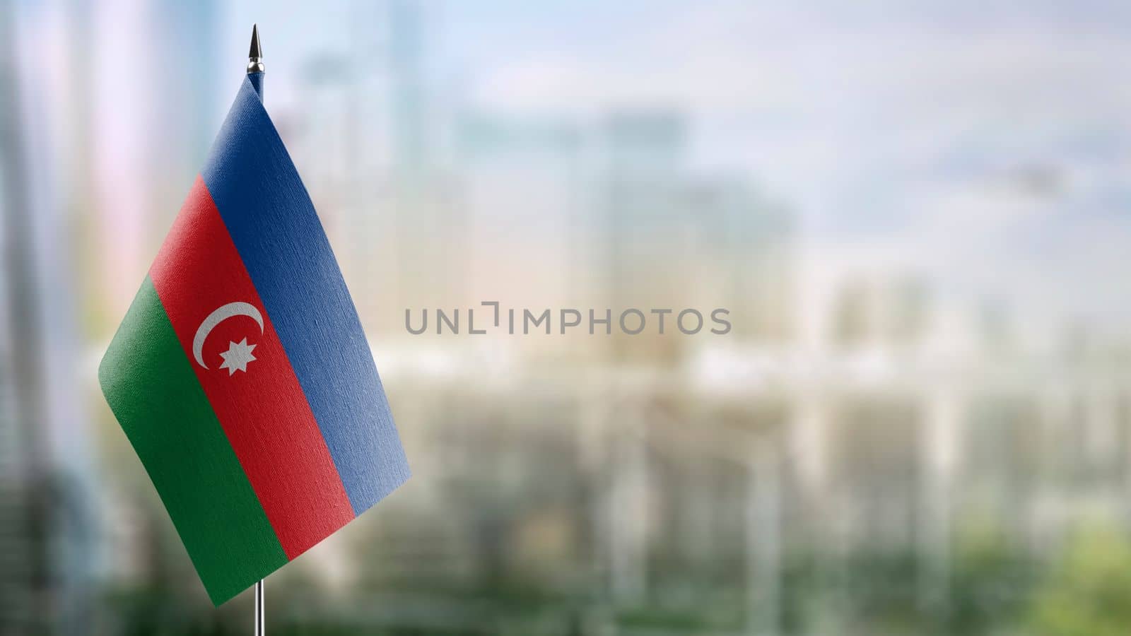 Small flags of the Azerbaijan on an abstract blurry background.