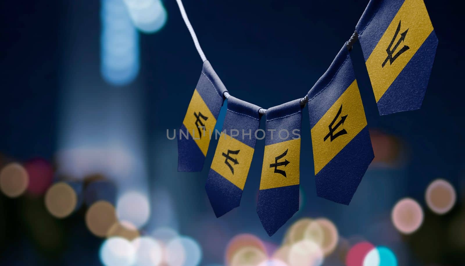 A garland of Barbados national flags on an abstract blurred background by butenkow