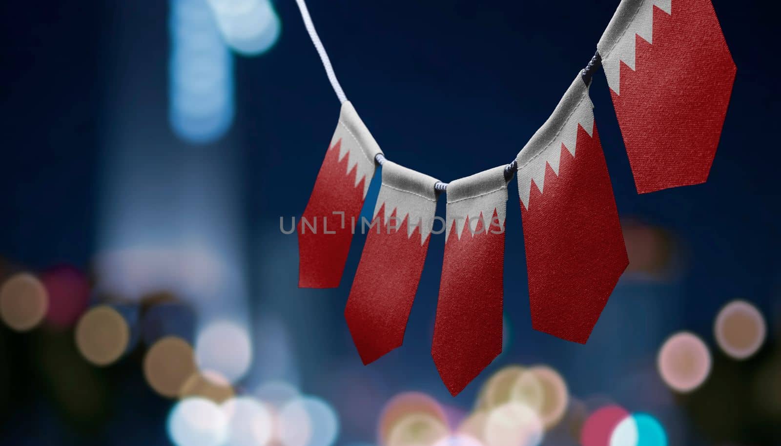 A garland of Bahrain national flags on an abstract blurred background by butenkow