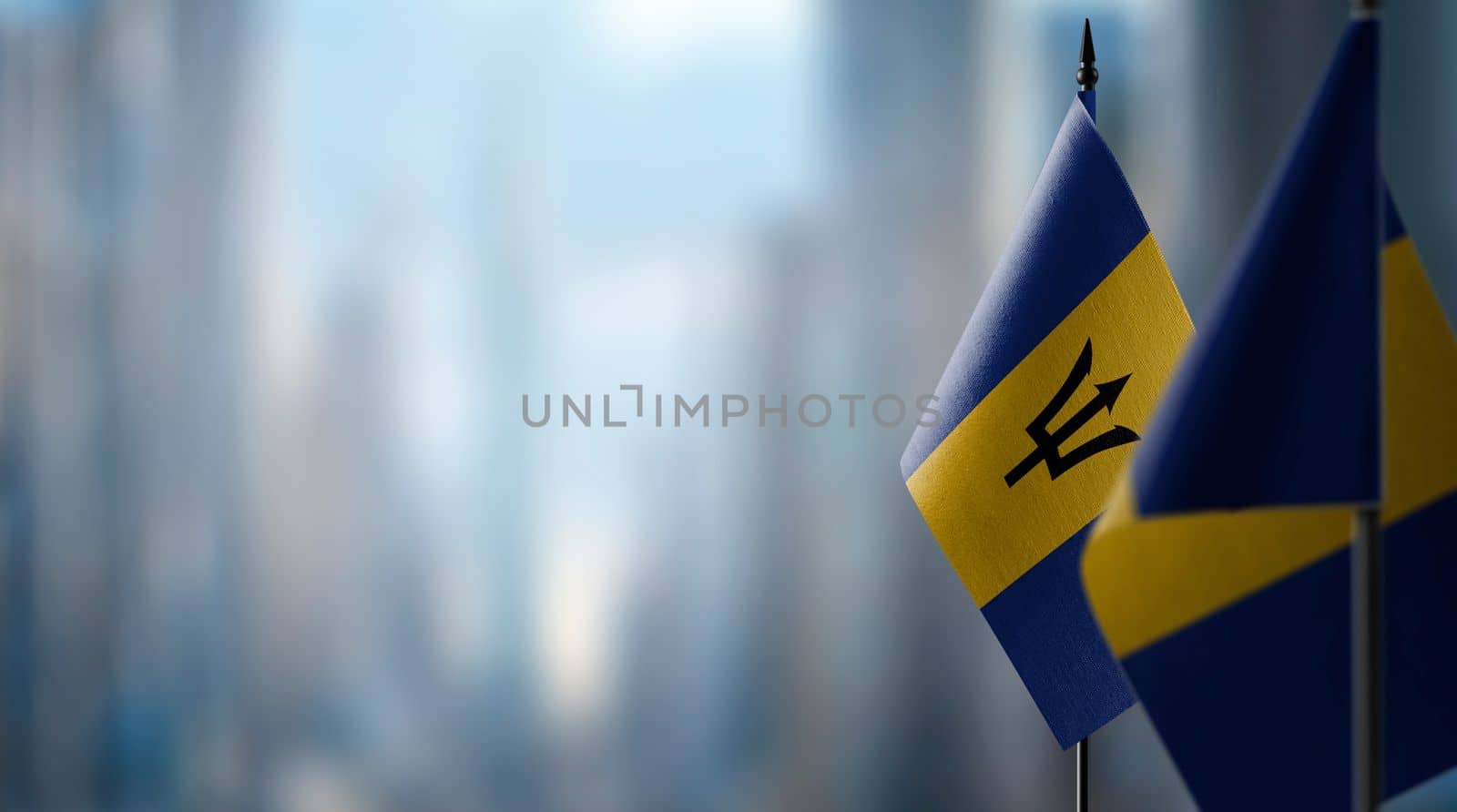Small flags of the Barbados on an abstract blurry background by butenkow