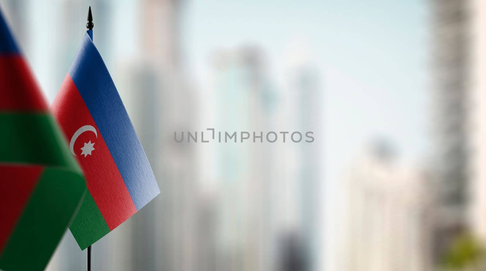 Small flags of the Azerbaijan on an abstract blurry background.