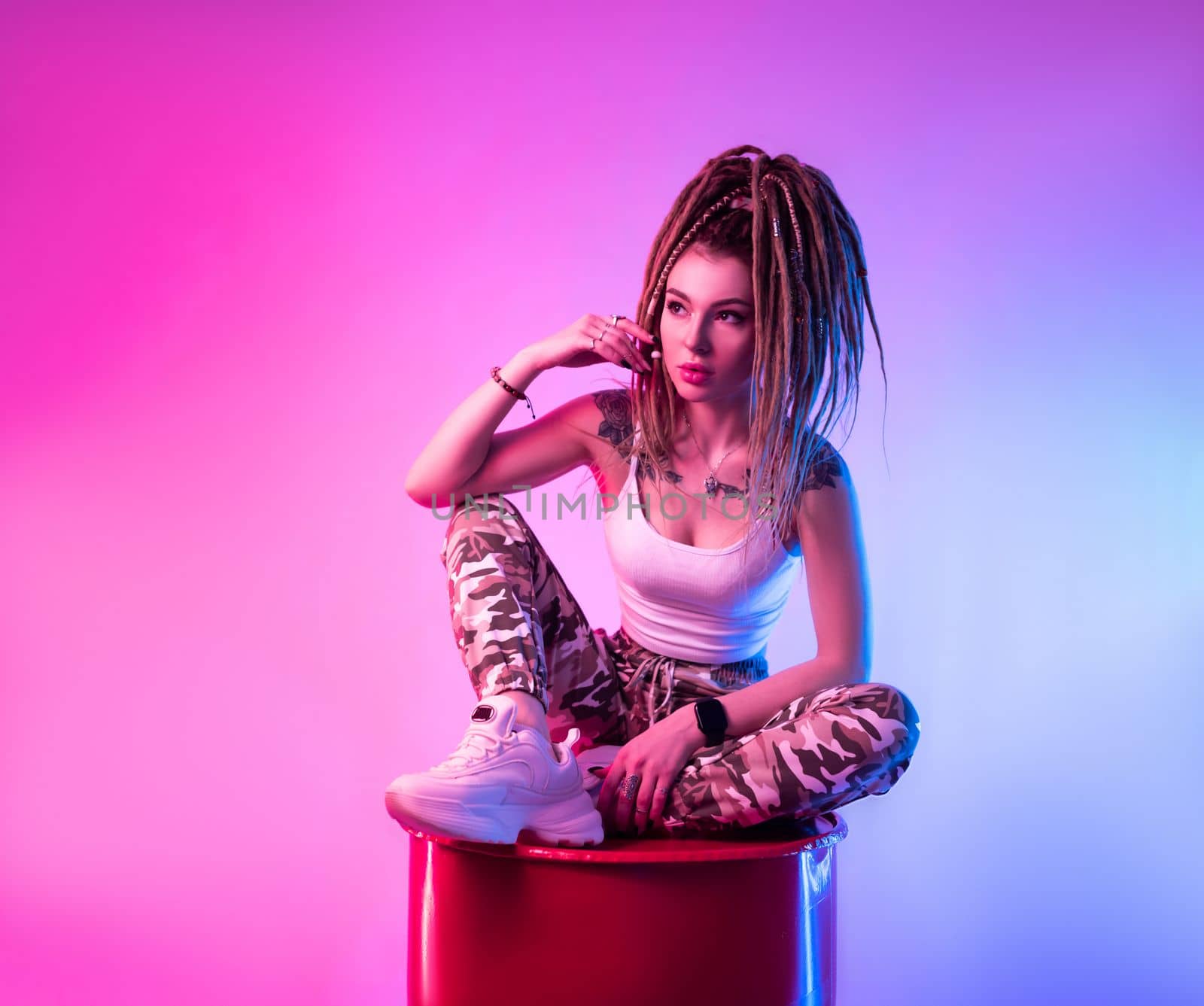 sexy girl with braided dreadlocks on her head in neon light on a light background copy paste by Rotozey