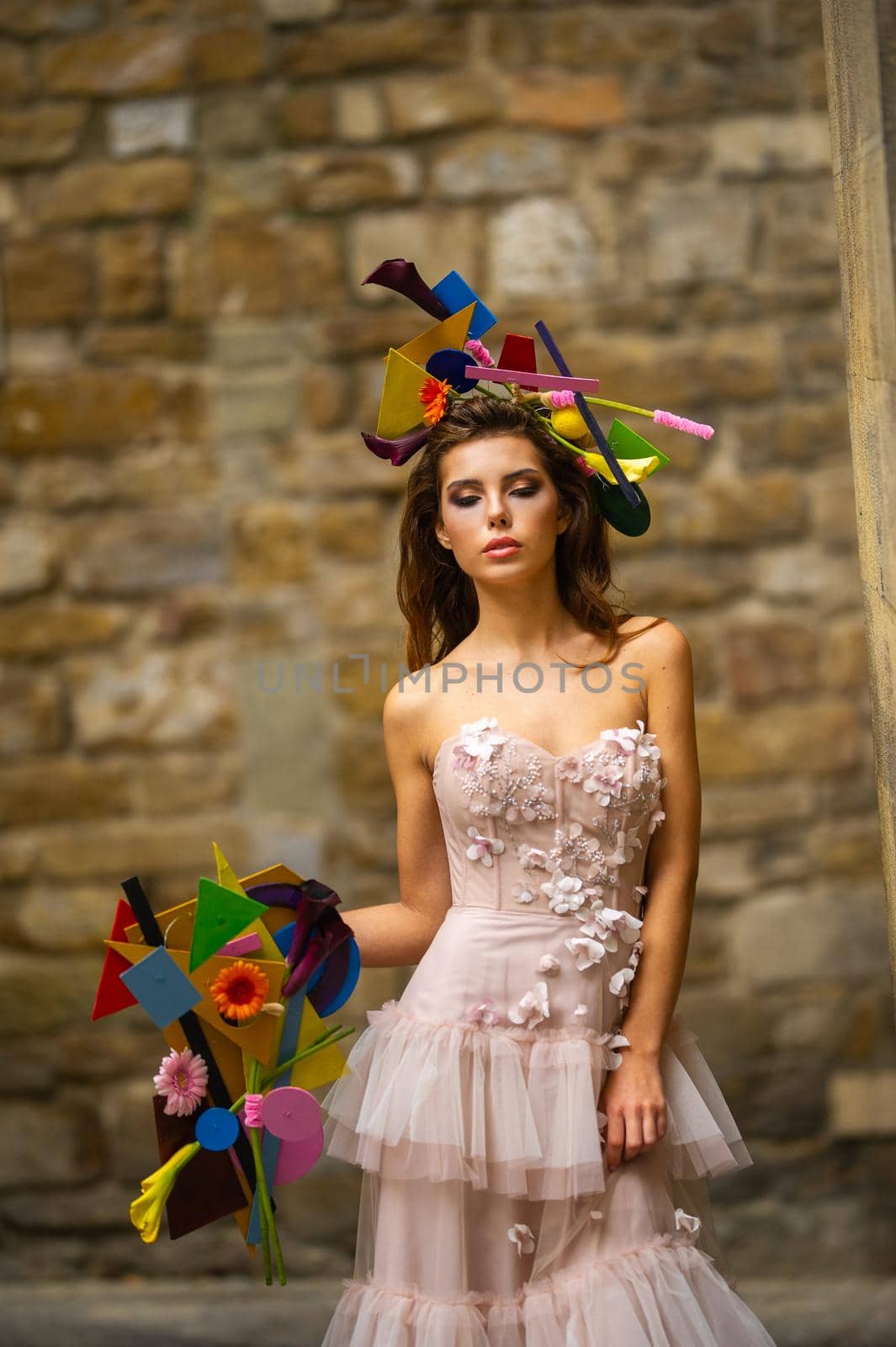 a bride in a pink wedding dress with an unusual bouquet and decoration in Gorova in Florence, Italy.