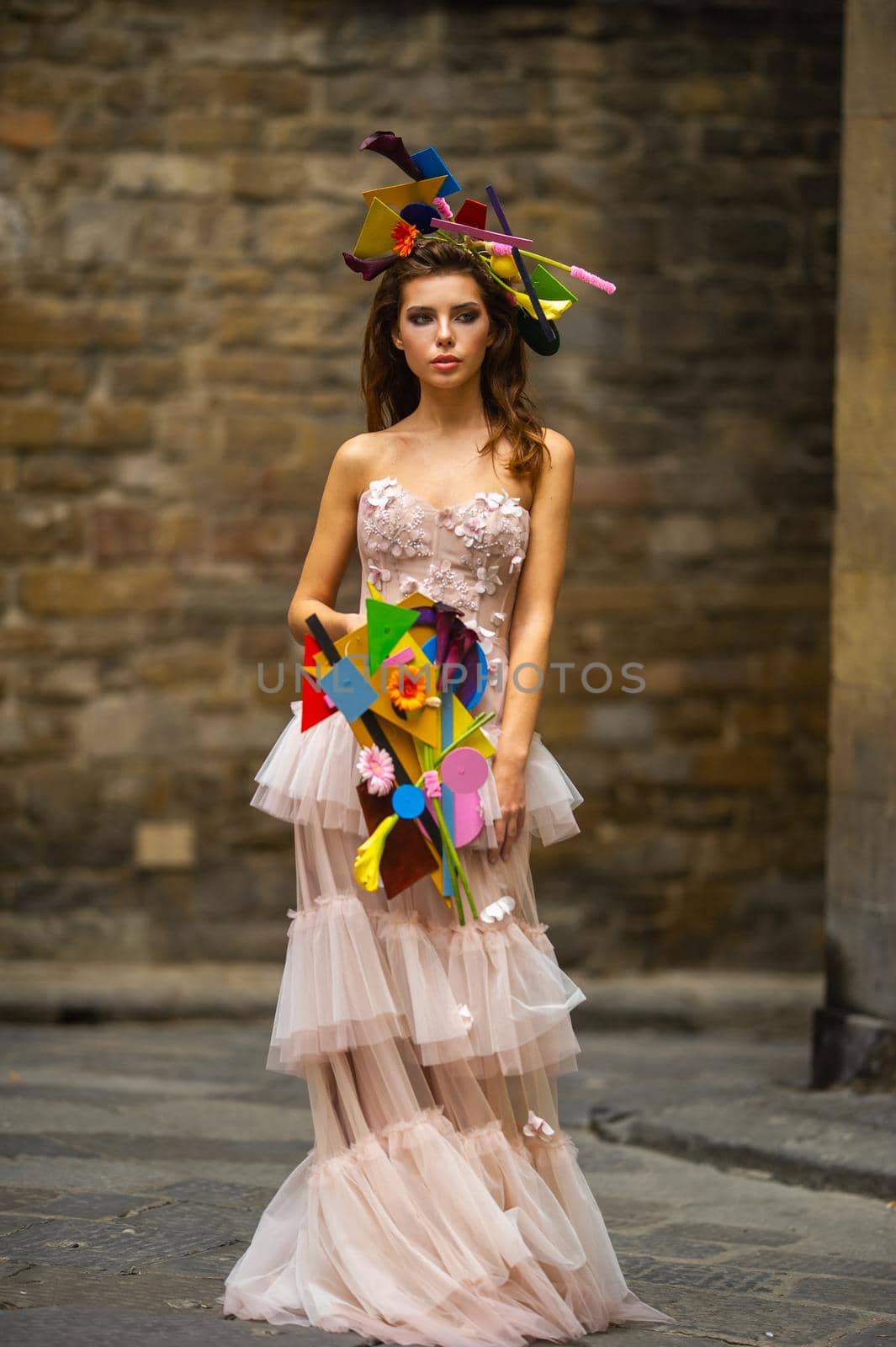 a bride in a pink wedding dress with an unusual bouquet and decoration in Gorova in Florence, Italy by Lobachad