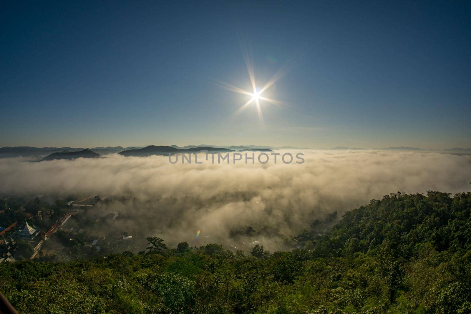 Morning fog covers Lamphun, Thailand, view from the viewpoint of Wat Phra That Pha Temple