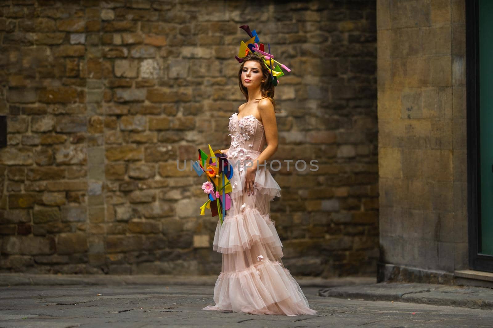 a bride in a pink wedding dress with an unusual bouquet and decoration in Gorova in Florence, Italy.