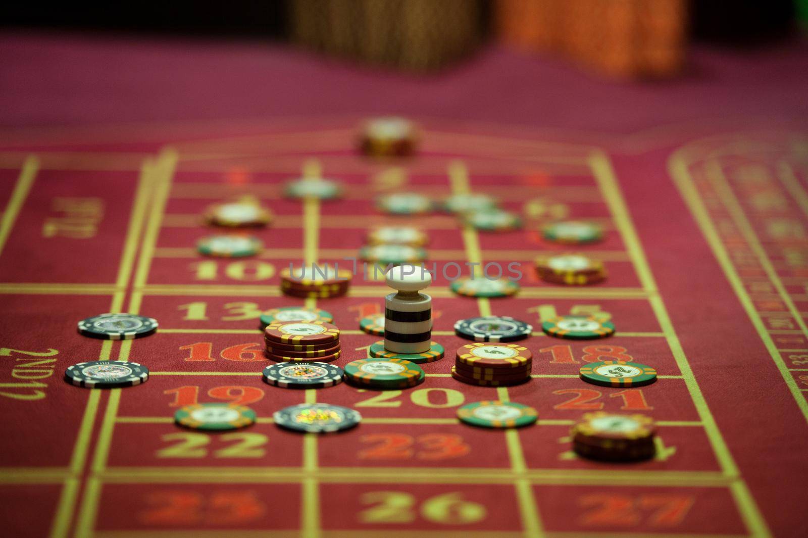 close-up of casino chips on the red table.