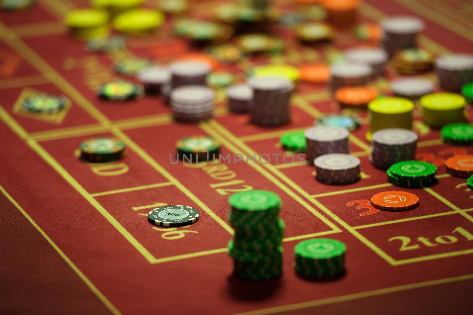 close-up of casino chips on the red table.