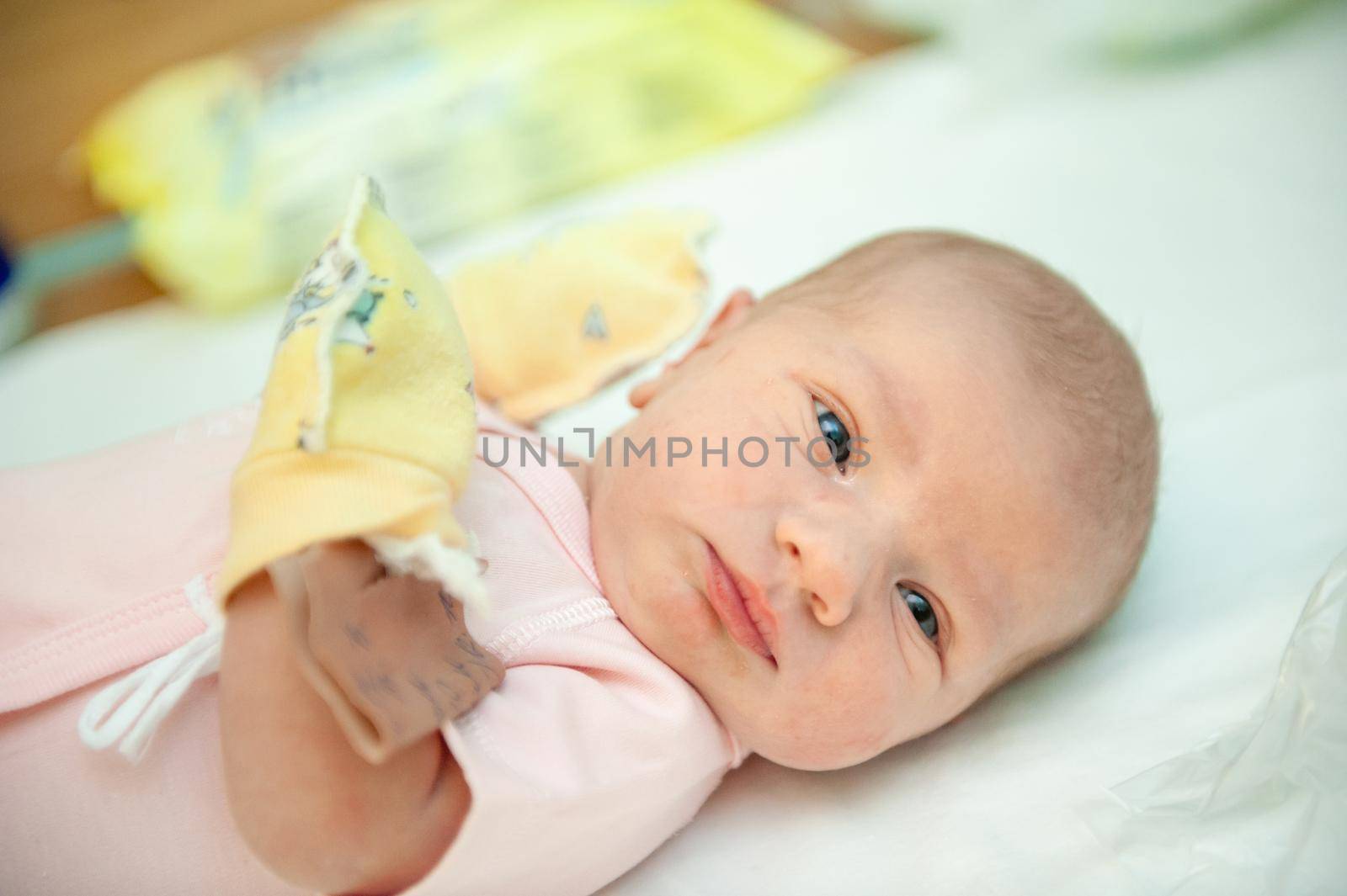 a newborn baby on the first day of its birth in the maternity hospital.