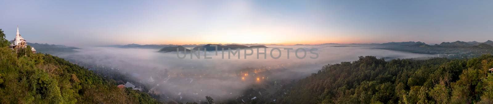 Fog covers the city of Lamphun, Thailand, view from the viewpoint of Wat Phra That Pha Nam by put3d