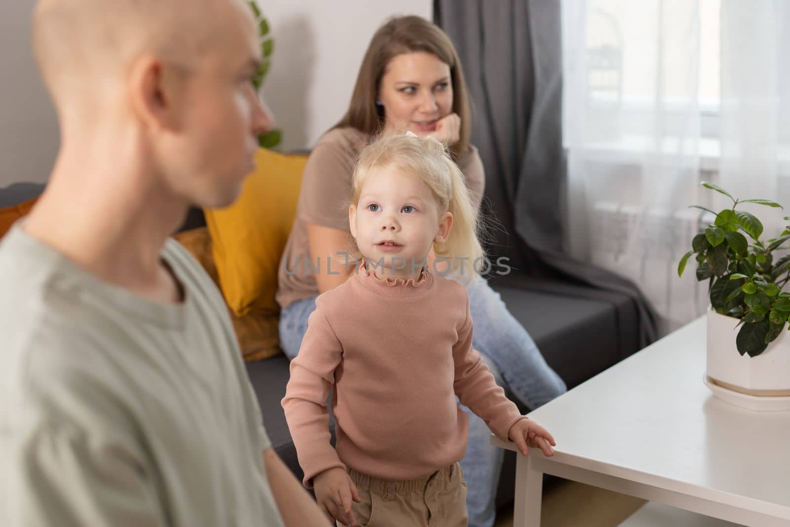 Deaf child girl with cochlear implant studying to hear sounds - recovery after cochlear Implant surgery and rehabilitation