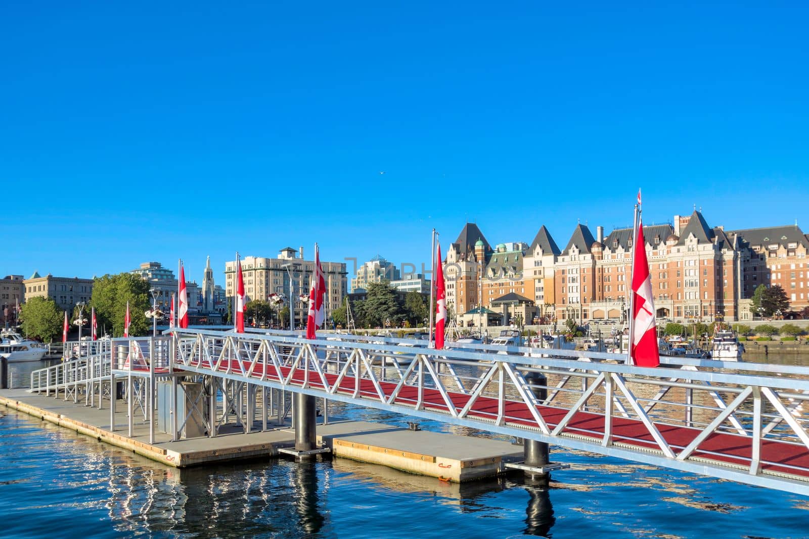 Metal ramp to a pier decorated with canadian flags at Victoria City center