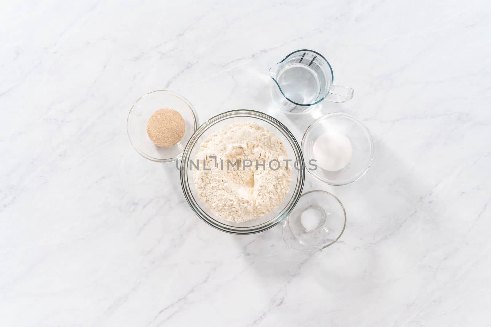 Flat lay. Measured ingredients in glass bowls to bake patriotic cinnamon twists.