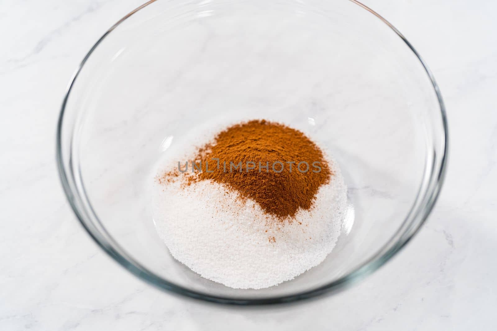 Mixing ingredients in a glass mixing bowl to bake patriotic cinnamon twists.